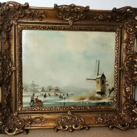 Dutch winter landscape with skaters and windmill in ornamental frame